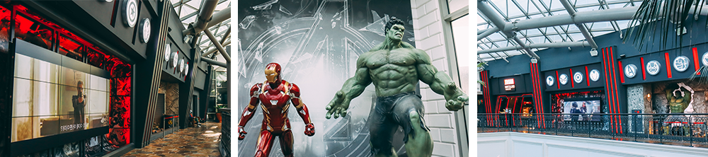 Left picture: The outside of the store from an angle with the dark green background of the wall stretching off down the walkway; middle picture: Two figures of Iron Man and Hulk standing tall as they did in the Avengers movie; right picture: Another shot of the store front at a distance across the mall main area with the Marvel red color placed in areas on the wall to complement the green background