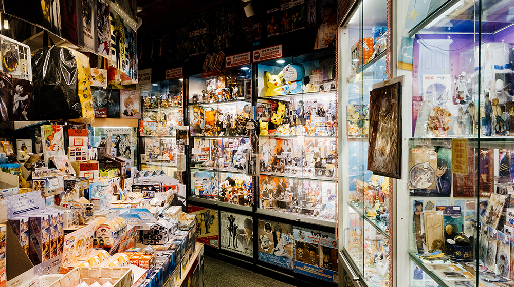 A wide array of dolls and figurines out on display with some others locked away in display cases, including those from Pokemon and other anime series